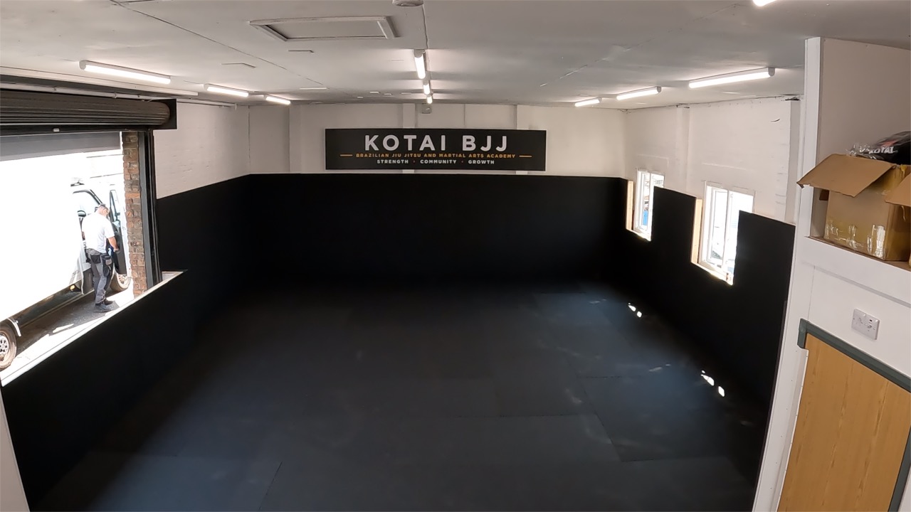 Wide view across the finished Kotai BJJ academy training space